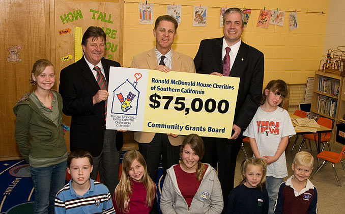 Children in a Classroom receiving a $75,000 Grant Check