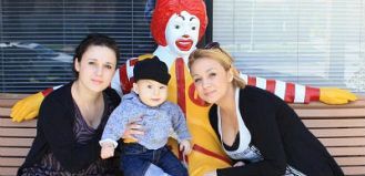 Family Posing by a Ronald Statue 