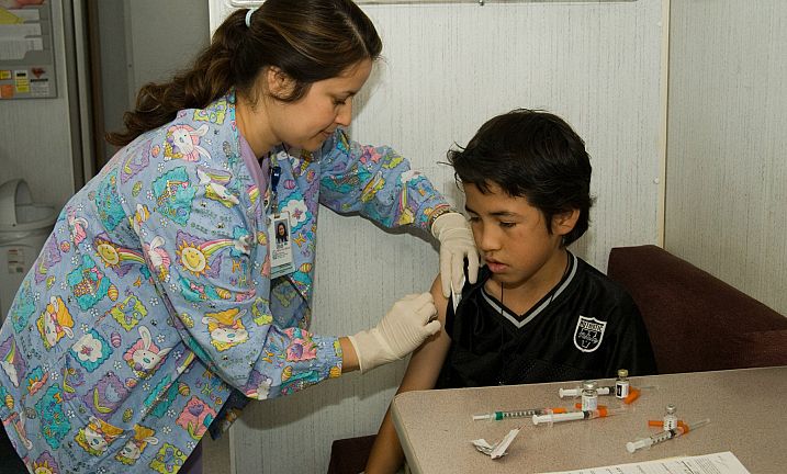 Nurse giving immunization Shot to Child 