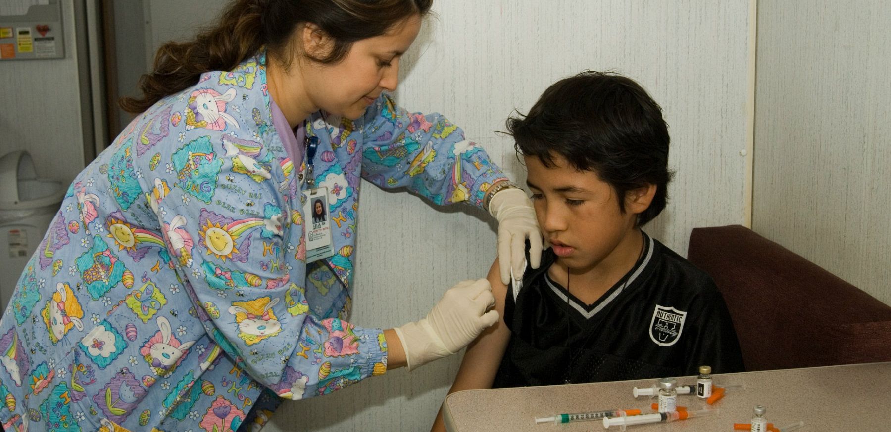 Nurse giving immunization Shot to Child 